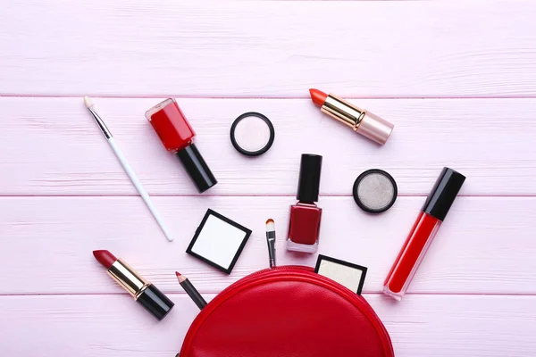 Different makeup cosmetics on pink wooden table — Stock Photo, Image