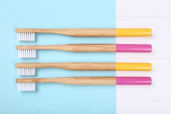 Bamboo toothbrushes on colorful background