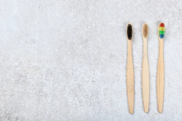 Bamboo toothbrushes on grey background — Stock Photo, Image