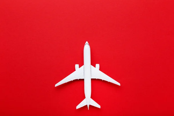Airplane model on red paper background — Stock Photo, Image