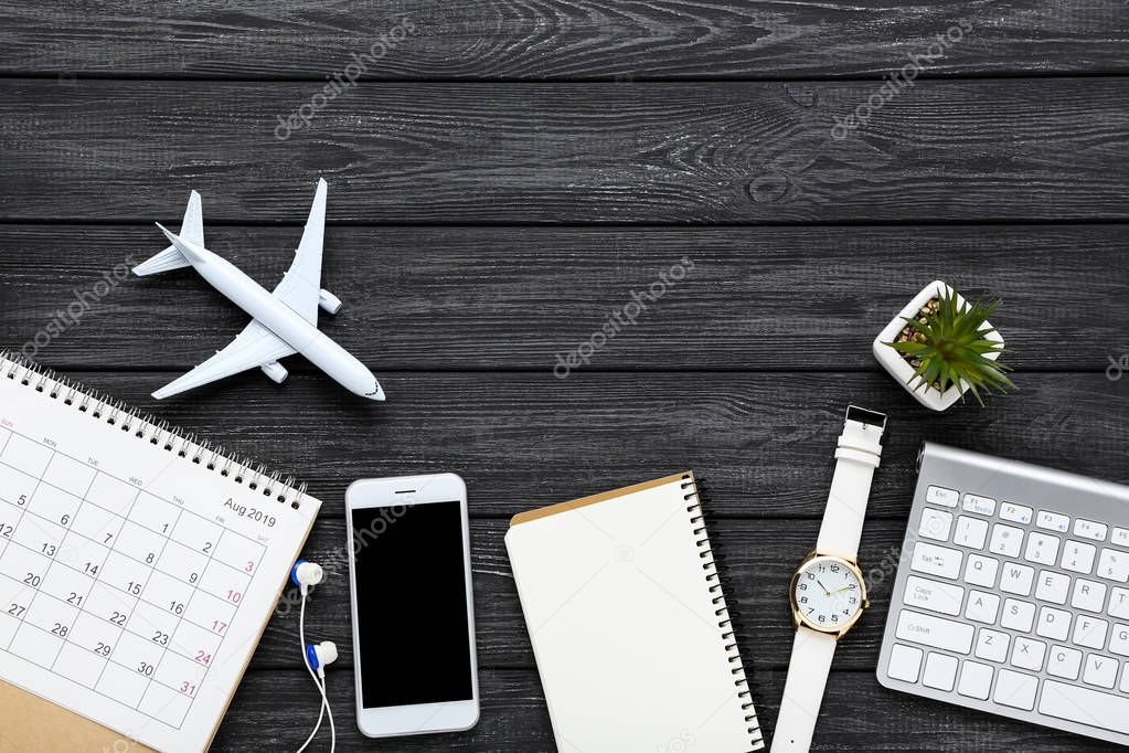 Airplane model with paper calendar, smartphone, notepad and keyp