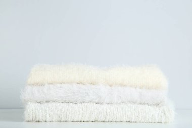 Gri arka plan üzerinde katlanmış kazak yığını