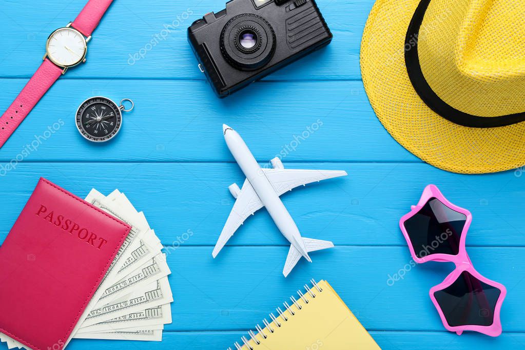 Airplane model with passport, dollar banknotes, hat, sunglasses 