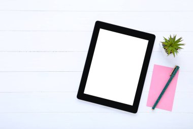 Yeşil bitki ve beyaz ahşap pembe kağıt ile Tablet bilgisayar 