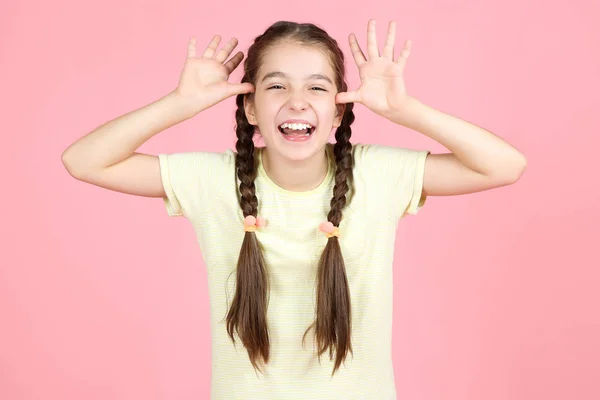 Happy young girl on pink background — Stock Photo, Image