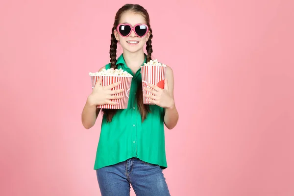 Krásná mladá dívka držící kbelíky s popcornem na růžovém působivý — Stock fotografie