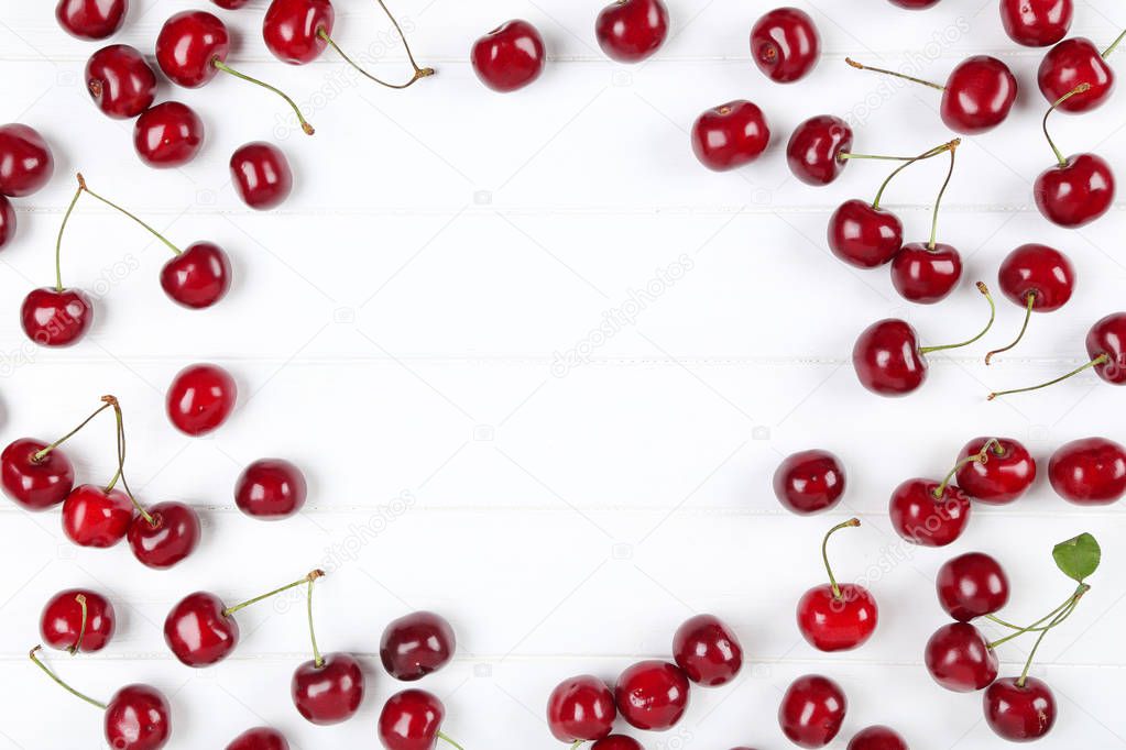 Sweet cherries on white wooden table
