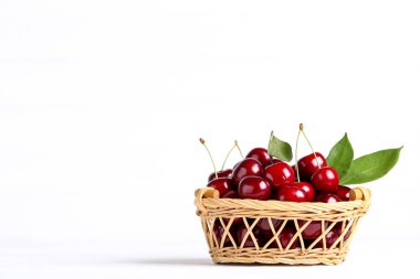 Sweet cherries in basket on white background