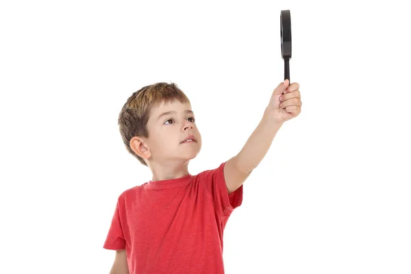 Niño pequeño con lupa sobre fondo blanco —  Fotos de Stock