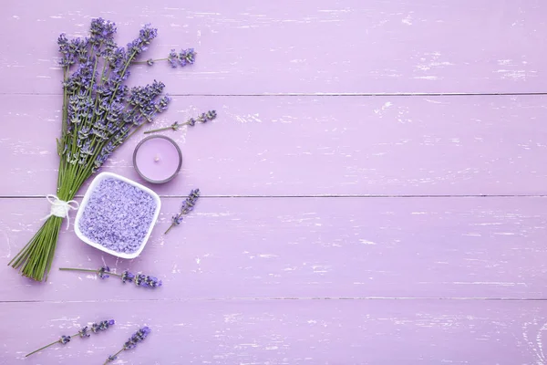 Lavender flowers with spa salt and candle on purple wooden table — Stock Photo, Image