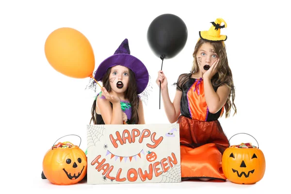 Two young girls in costumes with pumpkin buckets and text Happy — Stock Photo, Image