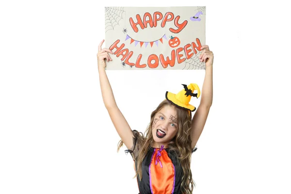 Beautiful girl in costume holding paper with text Happy Hallowee — Stock Photo, Image