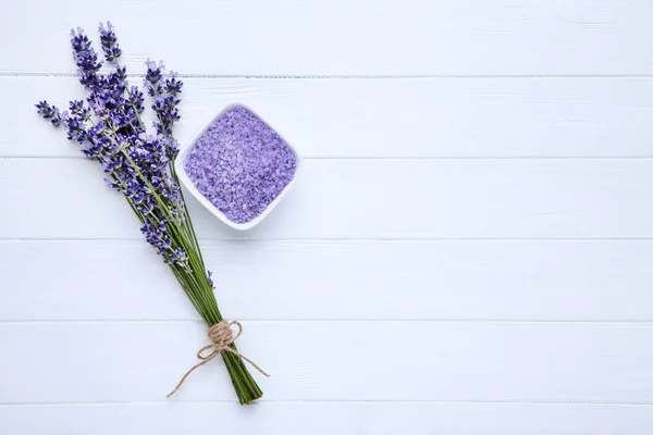Lavender flowers and spa salt on white wooden table — Stock Photo, Image