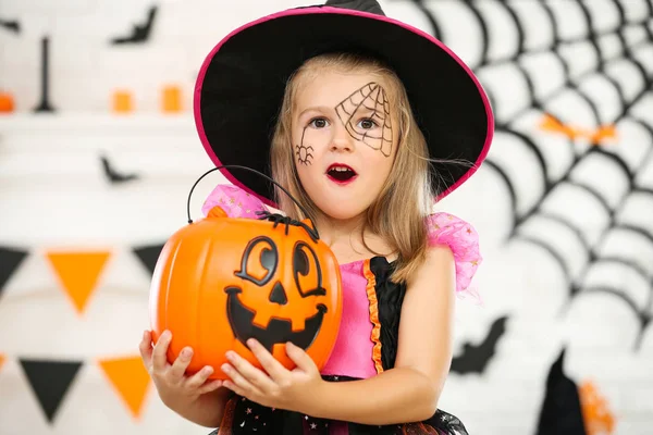 Chica joven en traje de halloween sosteniendo cubo de calabaza —  Fotos de Stock
