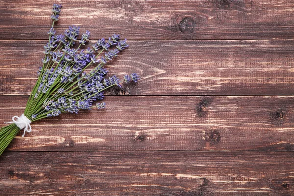 Lavender flowers on brown wooden table — Stock Photo, Image