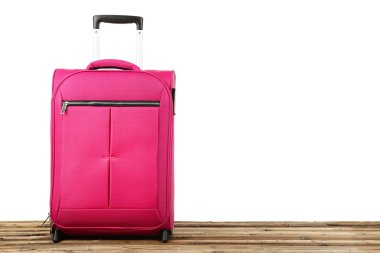 Tahta masadaki pembe bavul.