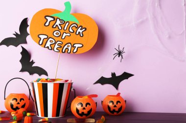 Mor b üzerinde şeker ve balkabağı kovalarıyla şaka ya da ikram metni