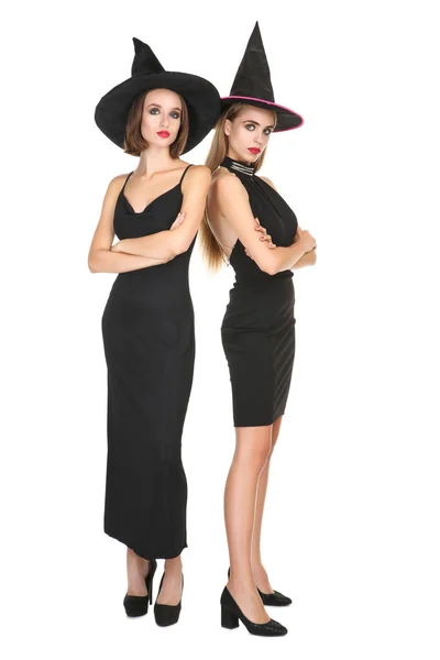 Two young women in black halloween costumes on white background — Stock Photo, Image