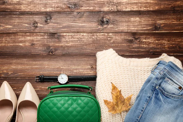 Ropa de moda con hoja de arce en mesa de madera marrón — Foto de Stock