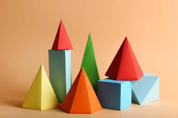 Colorful paper geometric figures on beige background — 스톡 사진