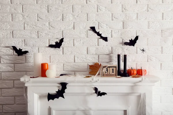 Halloween decorations on white fireplace