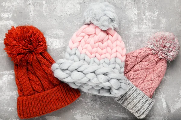 Knitted hats on grey background — Stock Photo, Image