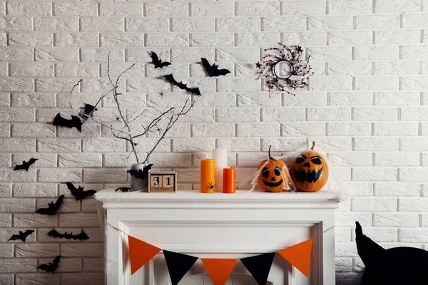 Halloween decorations on white fireplace