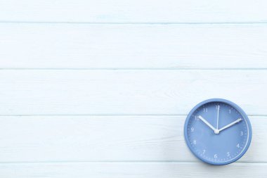 Ahşap masada mavi yuvarlak saat