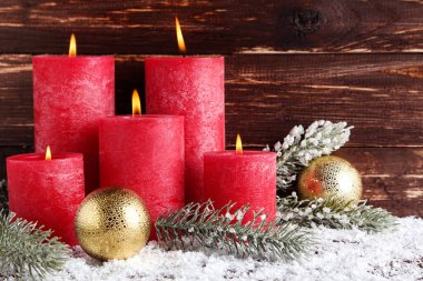 Mücevherli Noel mumları ve kahverengi renkli ağaç dalları.