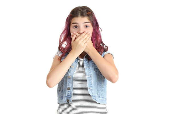 Beautiful young girl closing mouth by hands on white background