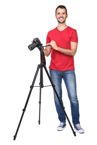 Junger Fotograf mit Kamera auf Stativ isoliert auf weißem Rücken — Stockfoto