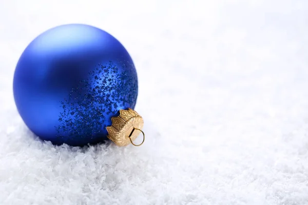 Christmas bauble on white snow Stock Photo