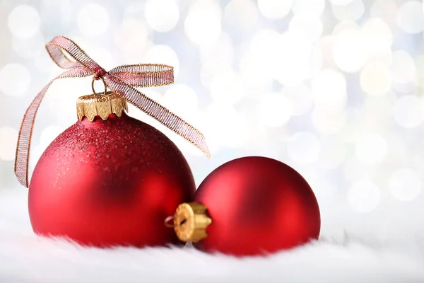 Christmas red baubles with ribbon bow on blurred background Stock Image