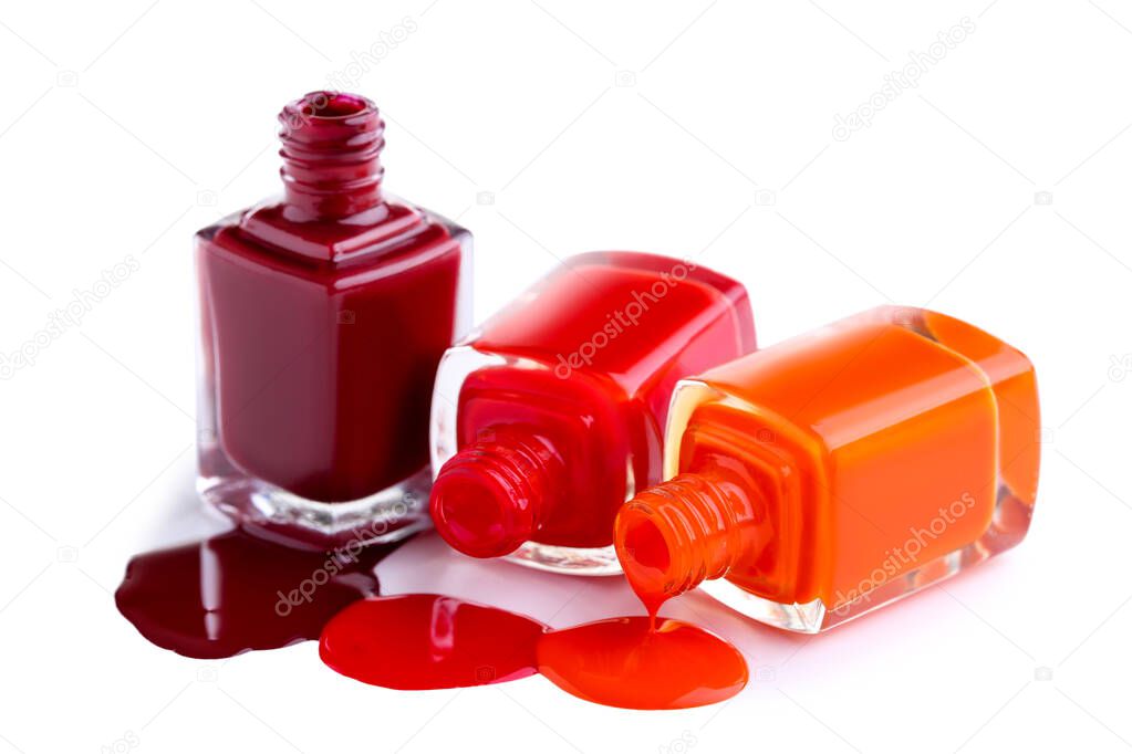 Nail polish splatters and bottles on white background