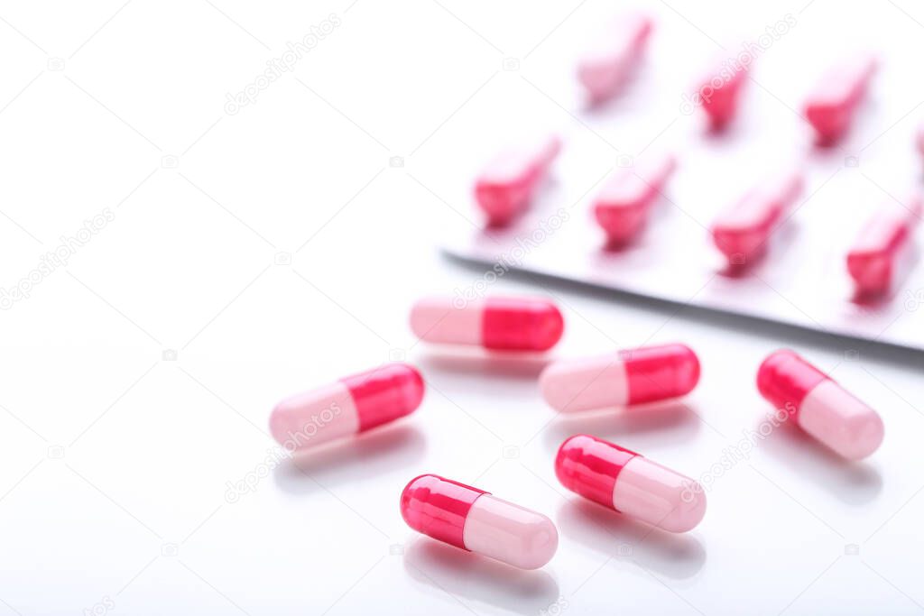 Pills and blisters on white background