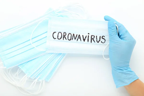 Text Stop Coronavirus with medicine masks on white background