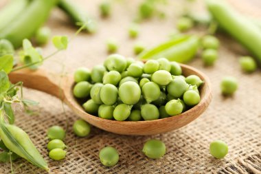 Green peas in spoon with sackcloth clipart