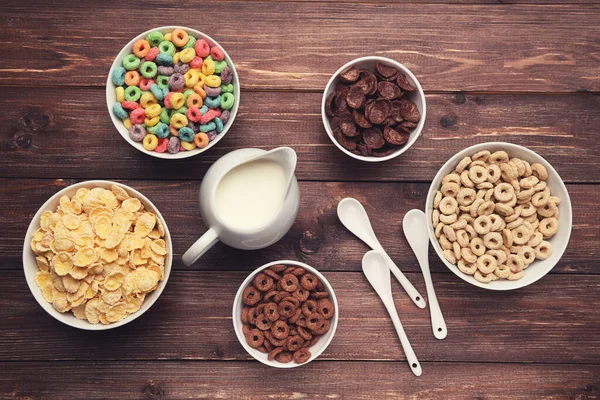 Various Corn Flakes Milk Jar Spoons Brown Wooden Table — Stock Photo, Image