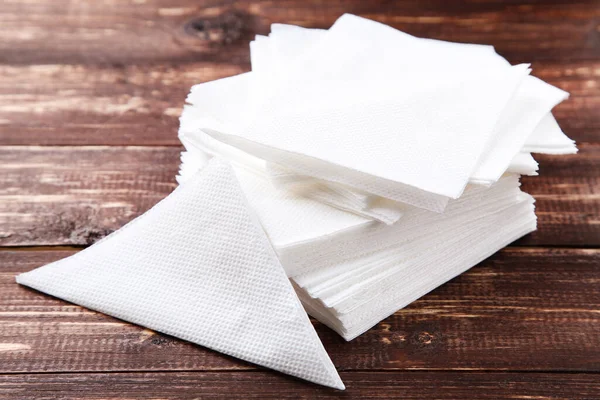 Paper napkins on brown wooden table