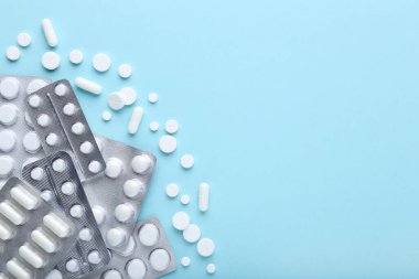 Mavi arka planda su toplayan beyaz haplar.