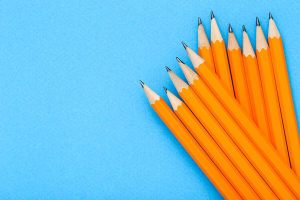 Yellow pencils on blue background