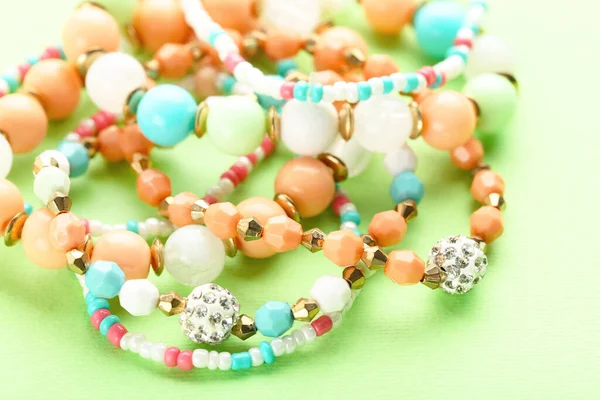 Beautiful Bracelets Green Background — Stock Photo, Image