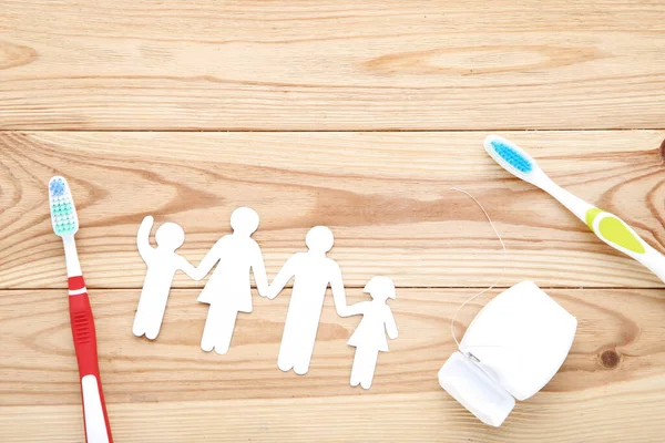 Family Figures Toothbrushes Brown Wooden Table — Stock Photo, Image