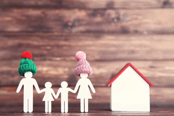 Wooden Family Figures Hats House Brown Background — Stock Photo, Image