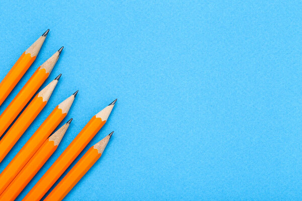 Yellow pencils on blue background