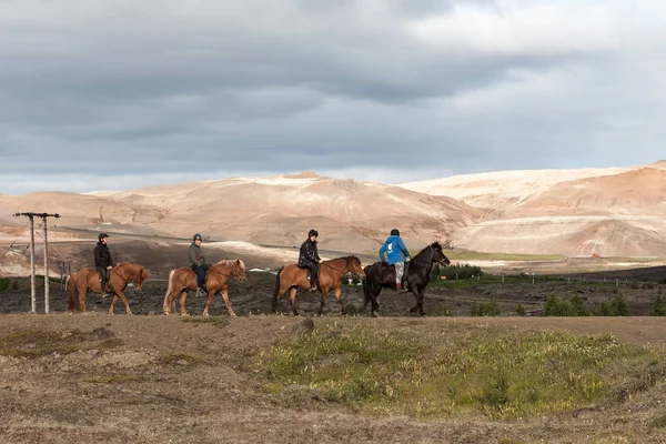 Myvatn Lake Iceland  Jul 31 2016 Group of tourists riding Icelandic horses of brown and black — Stock Photo, Image