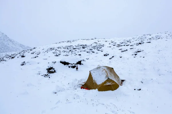 Tent in a snow Camping in bad weather Winter camping in mountains Tent in Himalayas after storm
