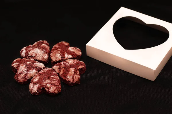 red chocolate cracked heart-shaped cookies with a white box. A gift for Valentine\'s Day, World Women\'s Day or Birthday