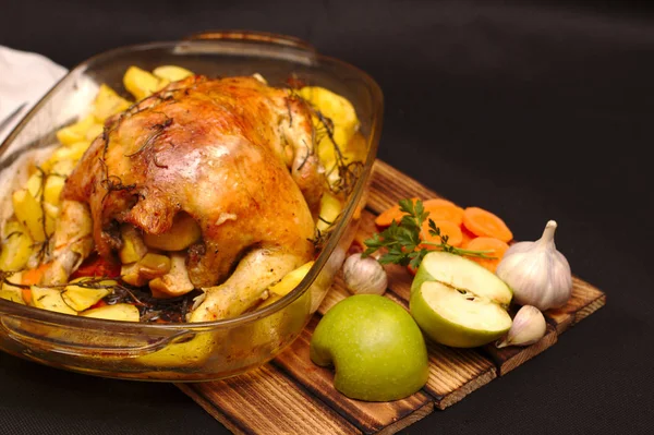 oven-baked crispy crust stuffed chicken on a plate with potatoes and apples