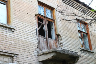 smashed a shot of an old brick building balcony at the Donbass in Ukraine clipart